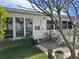 Enclosed back patio with multiple windows providing natural light and a seating area at 701 64Th Ave, St Pete Beach, FL 33706