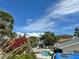 Beautiful pool and patio surrounded by lush tropical foliage under a sunny sky at 701 64Th Ave, St Pete Beach, FL 33706