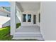 Spacious back porch with white pillars, three windows, and concrete flooring at 7258 Kodiak Ln, Sarasota, FL 34240