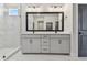 Bright bathroom with double vanity, framed mirror, and marble tile flooring at 7258 Kodiak Ln, Sarasota, FL 34240
