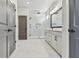 Bright bathroom featuring marble floors, a glass shower, and a sleek vanity with modern fixtures at 7258 Kodiak Ln, Sarasota, FL 34240