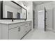Bathroom features white cabinets, marble countertop, double sink and large mirror at 7258 Kodiak Ln, Sarasota, FL 34240