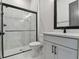 Modern bathroom features glass-enclosed shower and vanity with white countertop at 7258 Kodiak Ln, Sarasota, FL 34240