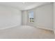Bright bedroom featuring neutral carpet, one window, and fresh white paint at 7258 Kodiak Ln, Sarasota, FL 34240