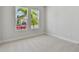 Well-lit bedroom offers neutral carpet, white trim, and double windows with outdoor view at 7258 Kodiak Ln, Sarasota, FL 34240