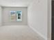 Bright bedroom featuring carpeted floors and two windows at 7258 Kodiak Ln, Sarasota, FL 34240