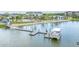 A scenic view of a boat dock, lake, and community clubhouse at 7258 Kodiak Ln, Sarasota, FL 34240