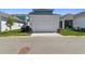 Charming exterior featuring a two-car garage, pristine lawn, and well-kept landscaping at 7258 Kodiak Ln, Sarasota, FL 34240