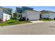 Charming exterior featuring a two-car garage, pristine lawn, and well-kept landscaping at 7258 Kodiak Ln, Sarasota, FL 34240