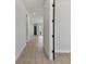Bright hallway featuring wood-look floors leading to a glass-paned door at 7258 Kodiak Ln, Sarasota, FL 34240