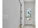 Hallway leading to a glass-paned door with an exterior view at 7258 Kodiak Ln, Sarasota, FL 34240