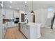 Modern kitchen showcasing an island, stainless steel appliances, and a staircase at 7258 Kodiak Ln, Sarasota, FL 34240