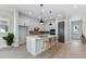 Modern kitchen boasts sleek white cabinets, large island, and stylish pendant lighting for a contemporary feel at 7258 Kodiak Ln, Sarasota, FL 34240