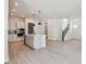 Bright, open-concept kitchen featuring a kitchen island, modern appliances, and easy access to the stairs at 7258 Kodiak Ln, Sarasota, FL 34240