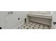 Well-lit laundry room featuring patterned tile floors and a built-in shelf for added storage at 7258 Kodiak Ln, Sarasota, FL 34240