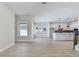 Open-concept area features a large window and view of the modern kitchen and stairs at 7258 Kodiak Ln, Sarasota, FL 34240