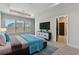 Main bedroom with a plush rug, large windows, and tray ceiling at 7258 Kodiak Ln, Sarasota, FL 34240