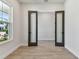 Office featuring wood-look floors, bright light, and glass doors at 7258 Kodiak Ln, Sarasota, FL 34240