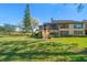 Scenic backyard view features mature landscaping, stairs to unit, and golf course views at 8003 Bardmoor Pl # 204, Seminole, FL 33777