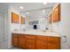 Bright bathroom featuring a double sink vanity and large, unframed mirror at 8003 Bardmoor Pl # 204, Seminole, FL 33777
