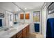 Bright bathroom featuring a double sink vanity, medicine cabinets and a large mirror at 8003 Bardmoor Pl # 204, Seminole, FL 33777