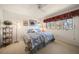 Bright bedroom featuring a large window, ceiling fan, and hardwood floors at 8003 Bardmoor Pl # 204, Seminole, FL 33777