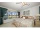 Bedroom with a golf course view, large windows, ceiling fan, and neutral décor at 8003 Bardmoor Pl # 204, Seminole, FL 33777