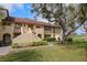 Inviting two-story condo with well-maintained landscaping and partial view of the golf course at 8003 Bardmoor Pl # 204, Seminole, FL 33777