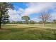 Scenic view of a golf course with lush green grass and trees at 8003 Bardmoor Pl # 204, Seminole, FL 33777