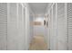 Hallway lined with multiple white, louvered closet doors at 8003 Bardmoor Pl # 204, Seminole, FL 33777