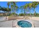 Hot tub with views of manicured landscaping, palm trees, and a lush green golf course at 8003 Bardmoor Pl # 204, Seminole, FL 33777