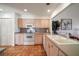 Bright kitchen with tile floors, white appliances and wood cabinets at 8003 Bardmoor Pl # 204, Seminole, FL 33777