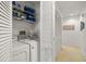 Laundry room with stacked storage shelving and louvered closet doors at 8003 Bardmoor Pl # 204, Seminole, FL 33777