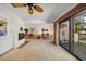 Open-concept living space with fireplace, dining area, and sliding glass doors to patio at 8003 Bardmoor Pl # 204, Seminole, FL 33777
