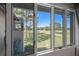 Beautiful window view of a lush green golf course from inside the residence at 8003 Bardmoor Pl # 204, Seminole, FL 33777