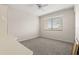 Bedroom featuring carpeted floor, window, and ceiling fan at 8141 Aquila St # 322, Port Richey, FL 34668