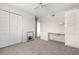 Spacious bedroom featuring a ceiling fan, carpeted floor, closet, and built-in desk at 8141 Aquila St # 322, Port Richey, FL 34668
