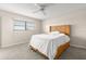 Inviting bedroom with carpet floors, a ceiling fan, and a comfortable wicker bed frame at 8141 Aquila St # 322, Port Richey, FL 34668
