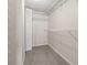 Walk-in closet featuring carpeted floors and multiple white wire shelves at 8141 Aquila St # 322, Port Richey, FL 34668