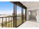 Enclosed patio showcasing scenic waterfront views and a seamless transition to a cozy bedroom, filled with natural light at 8141 Aquila St # 322, Port Richey, FL 34668
