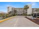 Exterior view of the condo building and parking lot at 8141 Aquila St # 322, Port Richey, FL 34668