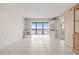 Bright living room featuring tile floors, built-in shelving and a balcony with scenic views at 8141 Aquila St # 322, Port Richey, FL 34668