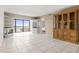 Bright living room featuring tiled floors, a built-in entertainment center, and seamless access to the water-view lanai at 8141 Aquila St # 322, Port Richey, FL 34668