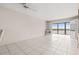 Spacious living room with tiled floors and a picturesque water view from the enclosed lanai, creating a bright open feel at 8141 Aquila St # 322, Port Richey, FL 34668