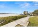 Breathtaking waterfront view from the property, featuring a serene waterway, lush greenery, and inviting bench at 8141 Aquila St # 322, Port Richey, FL 34668