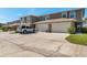 Exterior of townhomes showing driveways, garages, and mature landscaping at 8221 118Th Ave, Largo, FL 33773