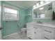 Bright bathroom with a white vanity, marble countertop, and light green walls at 9618 N 55Th St, Temple Terrace, FL 33617