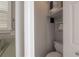 Cozy bathroom featuring a toilet, shelving unit, and a tank water heater for convenience at 9618 N 55Th St, Temple Terrace, FL 33617