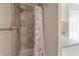 Bathroom shower with custom tile and seashell shower curtain at 9618 N 55Th St, Temple Terrace, FL 33617