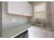 Bonus room with wet bar, white cabinets, and lots of natural light at 9618 N 55Th St, Temple Terrace, FL 33617